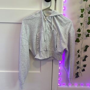 I am selling this grey cropped zip up. It is in a size XS. From garage.